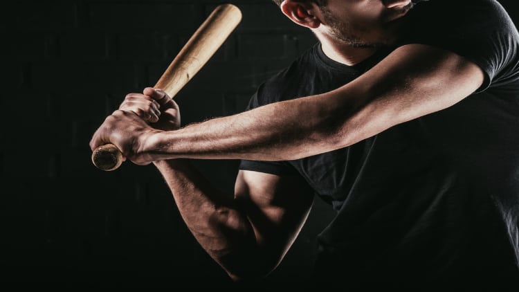 Man swinging a baseball bat