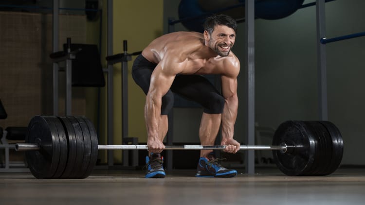 Man deadlifting a heavy barbell