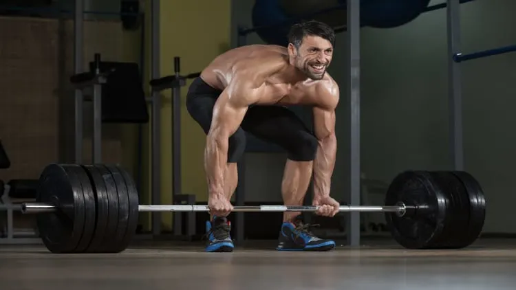 Man deadlifting a heavy barbell