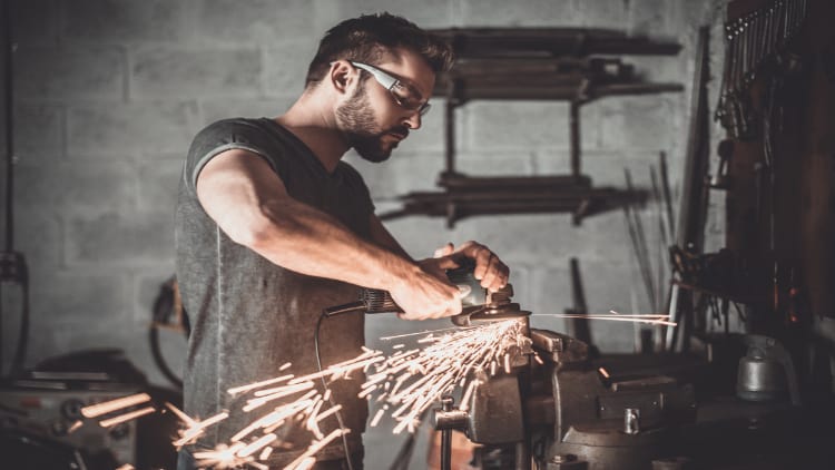 Man welding in garage