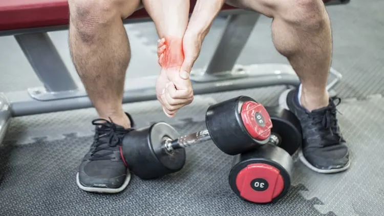 A man with wrist pain at the gym