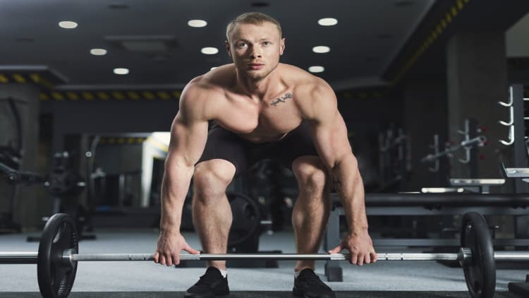 Man gripping the barbell during deadlifts