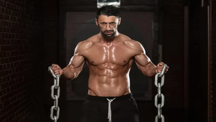 Fitness model doing bicep curls with chains