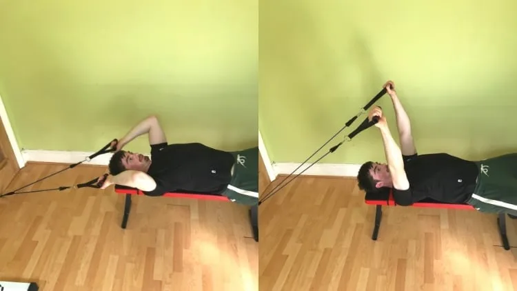 A man doing a lying resistance band tricep extension