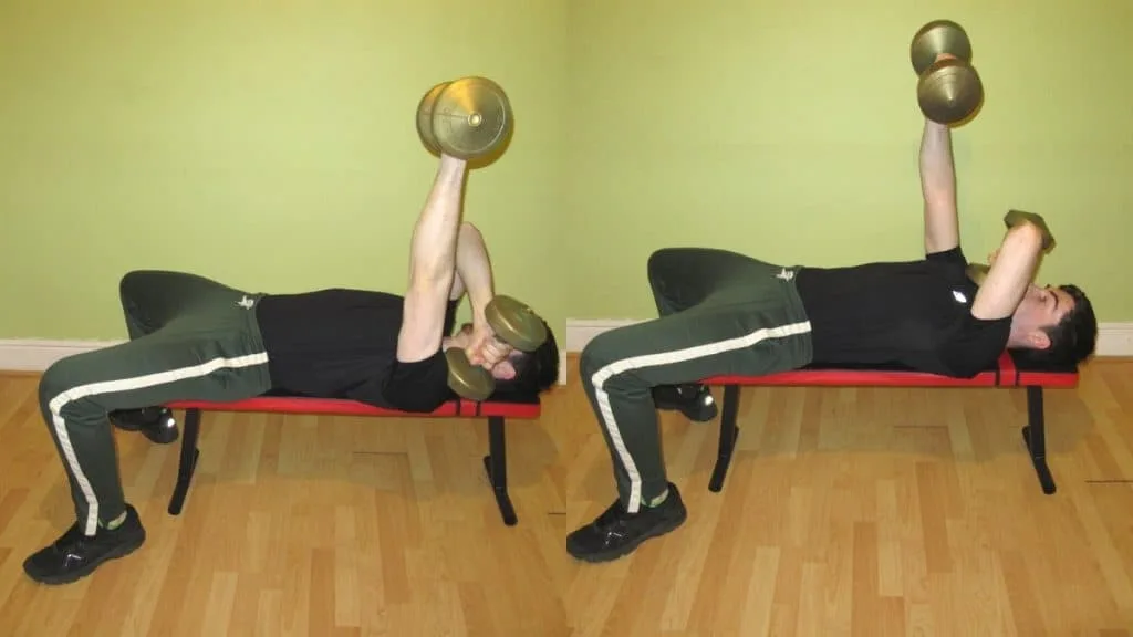 A man doing an alternating cross body triceps extension with dumbbells