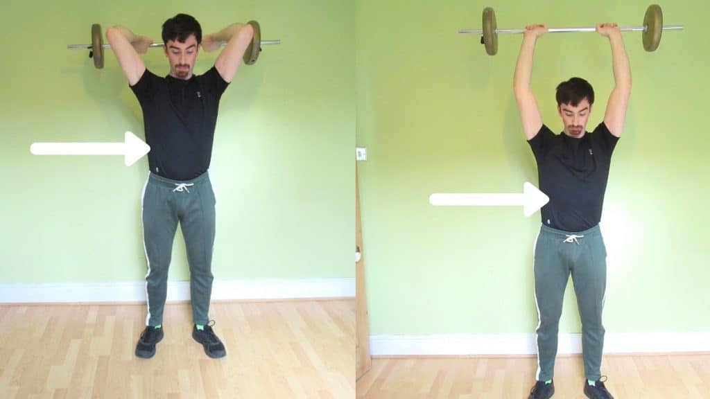 A man performing a barbell standing French press exercise for his triceps