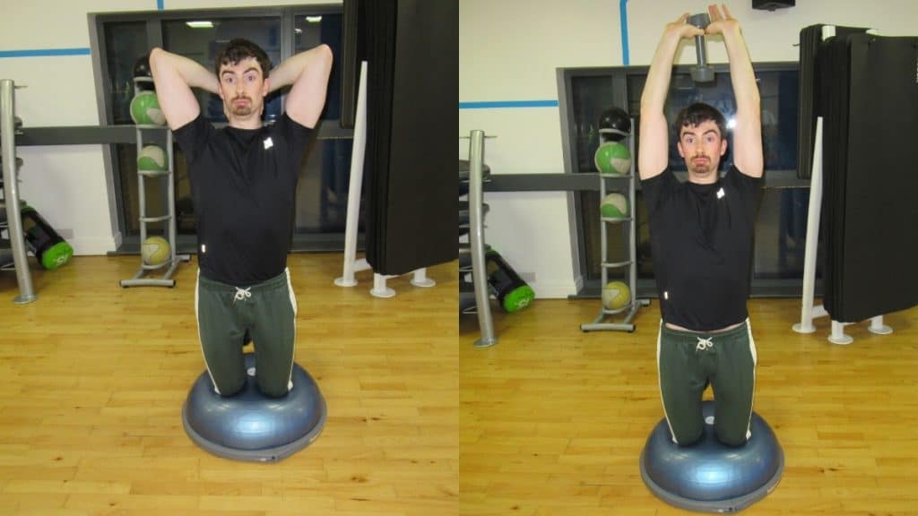 A man doing a BOSU ball kneeling dumbbell tricep-extension