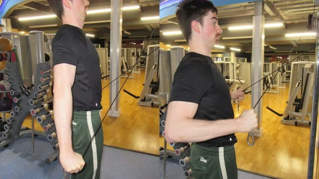 A man demonstrating the peak contraction during a cable cross tricep extension