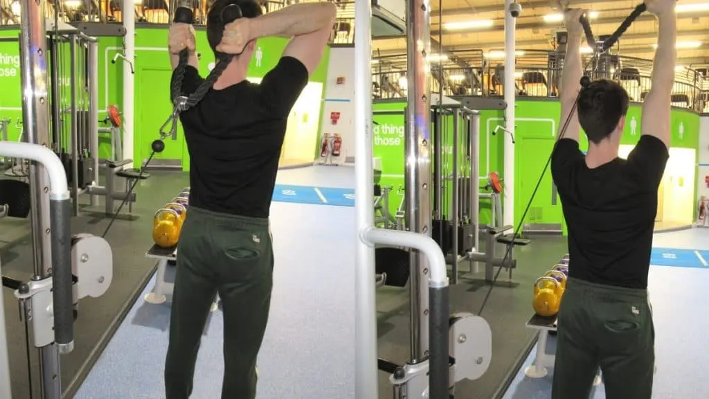 A man at the gym doing cable overhead extensions to train his triceps