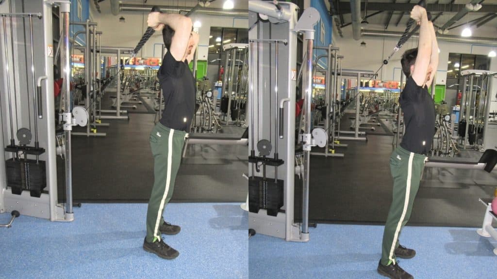 A man at the gym doing a cable overhead rope extension to work his triceps