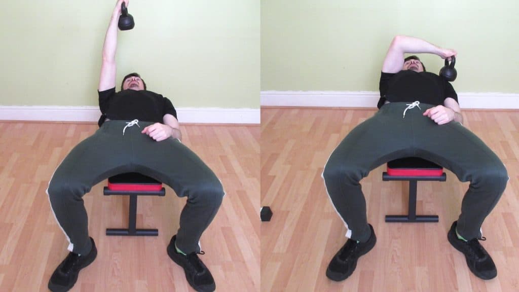 A man doing a cross body kettlebell tricep extension