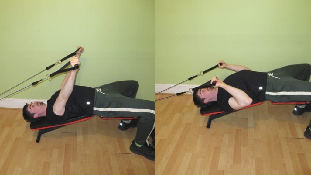 A man performing a decline resistance band tricep extension