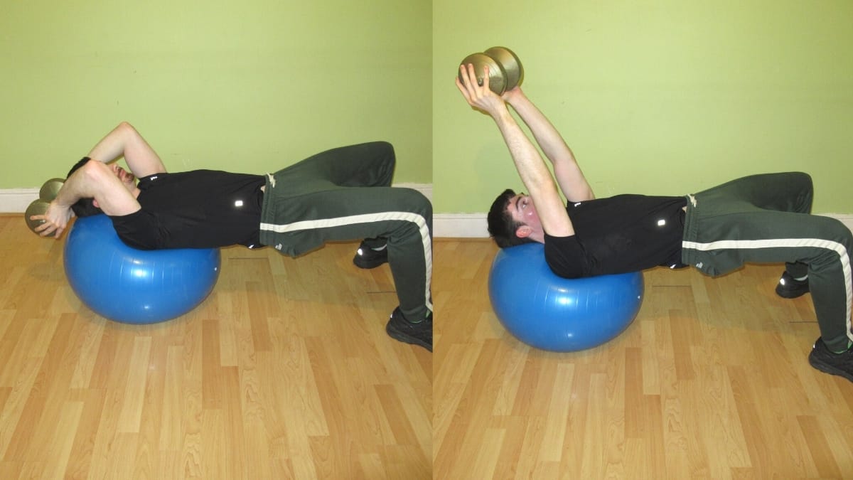 A man performing a French press on a stability ball with a dumbbell