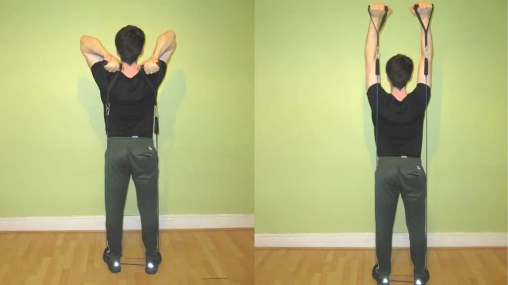 A man doing a French press with resistance bands during his workout