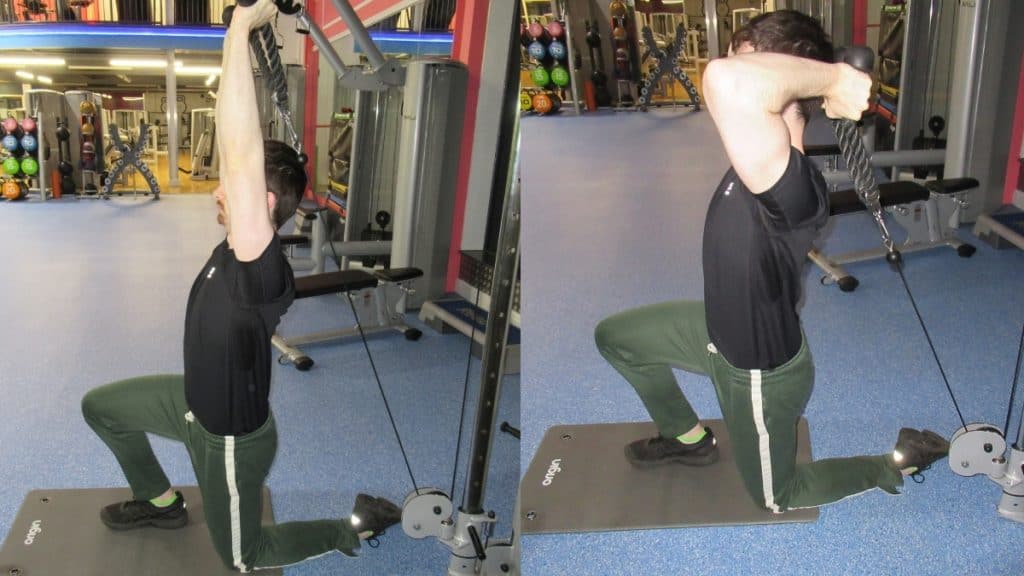 A man doing a half kneeling cable tricep extension