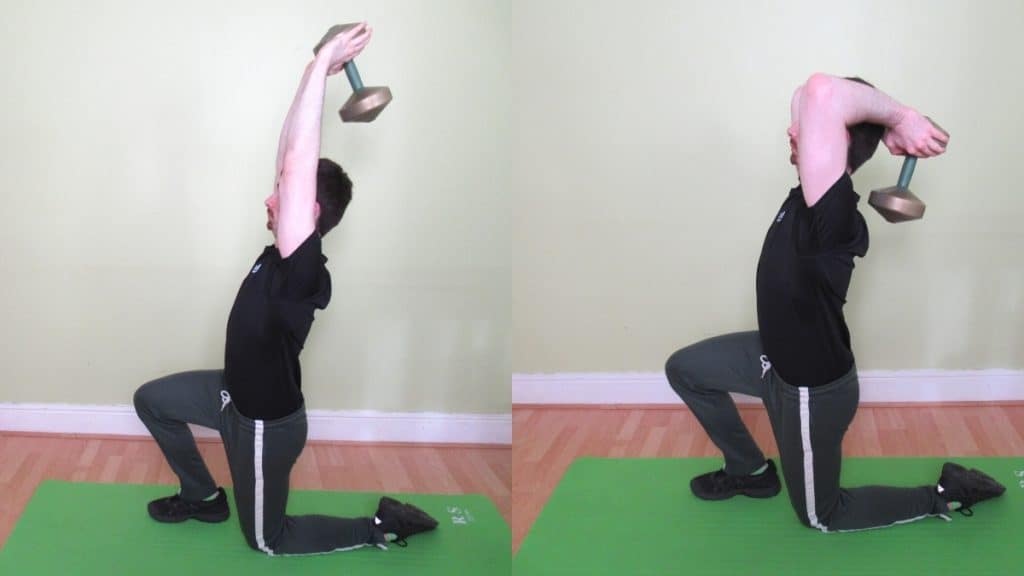 A man performing a half kneeling overhead extension with a dumbbell