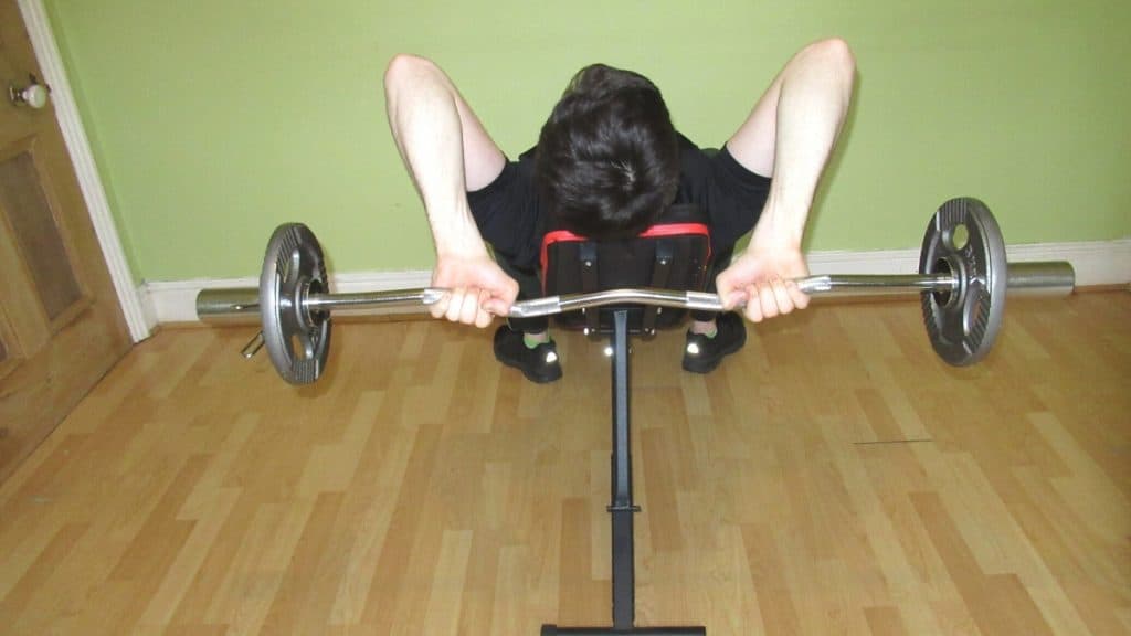 A man performing the incline French press exercise