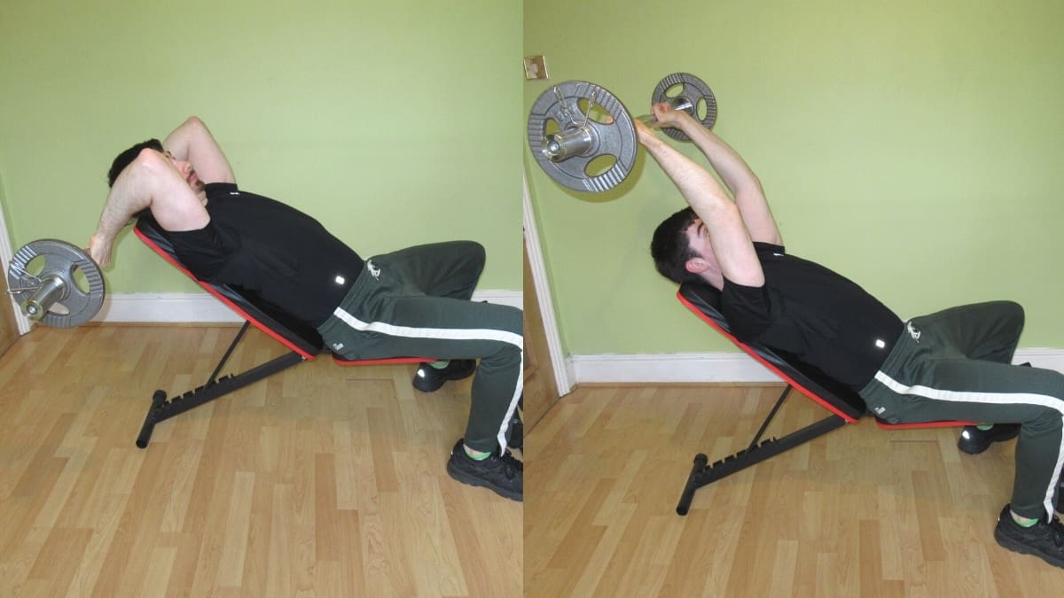 A man doing an incline French press with an EZ bar for his triceps