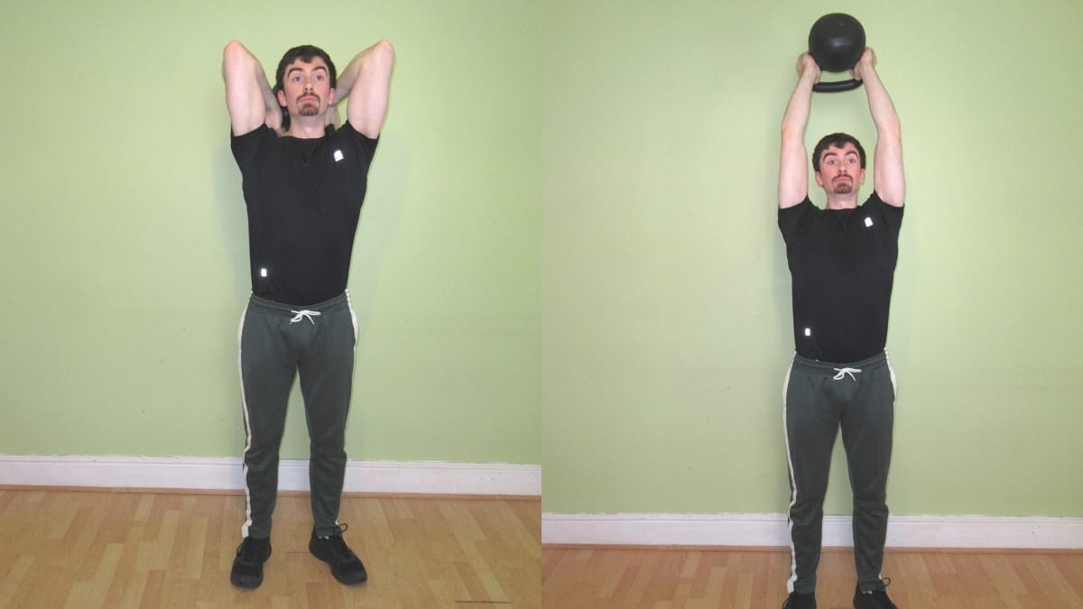 A man doing a standing kettlebell French press during his strength training workout