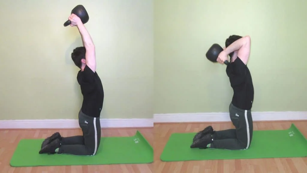 A man performing a kneeling kettlebell French press