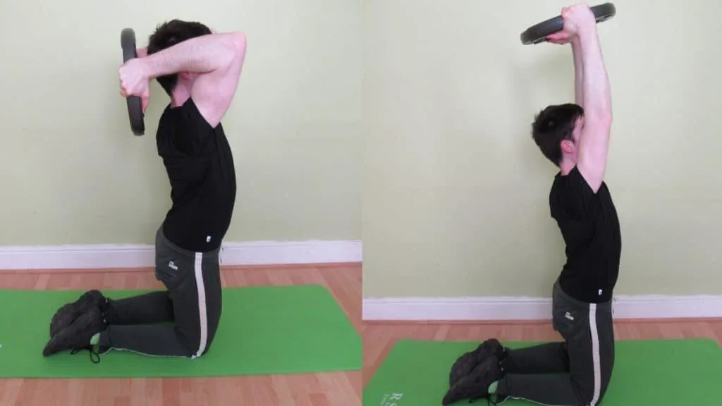 A man doing a kneeling plate triceps extension