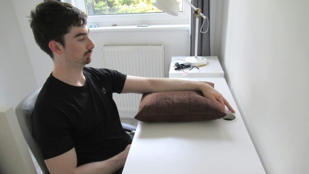 A man resting his elbow on a cushion