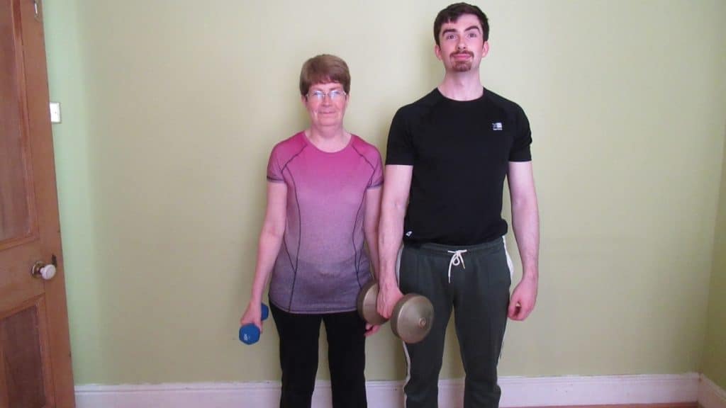 A sporty man and a woman holding some weights