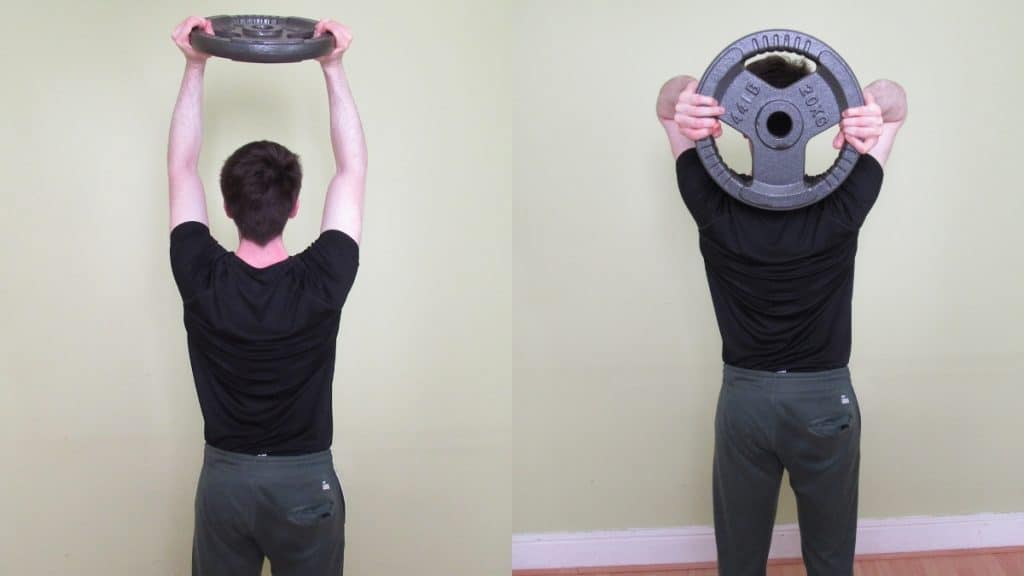 A man doing an overhead tricep extension with a weight plate