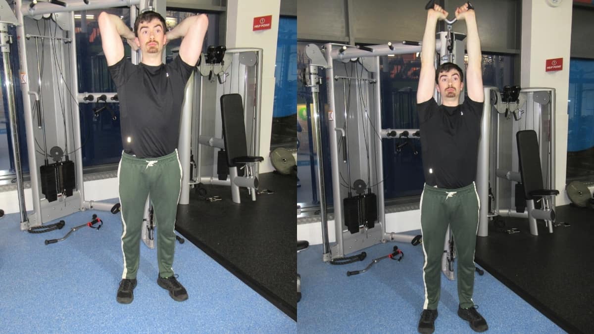 A man performing overhead v bar extensions for his triceps