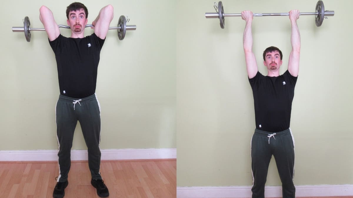 A man performing reverse grip overhead tricep extensions with an EZ bar