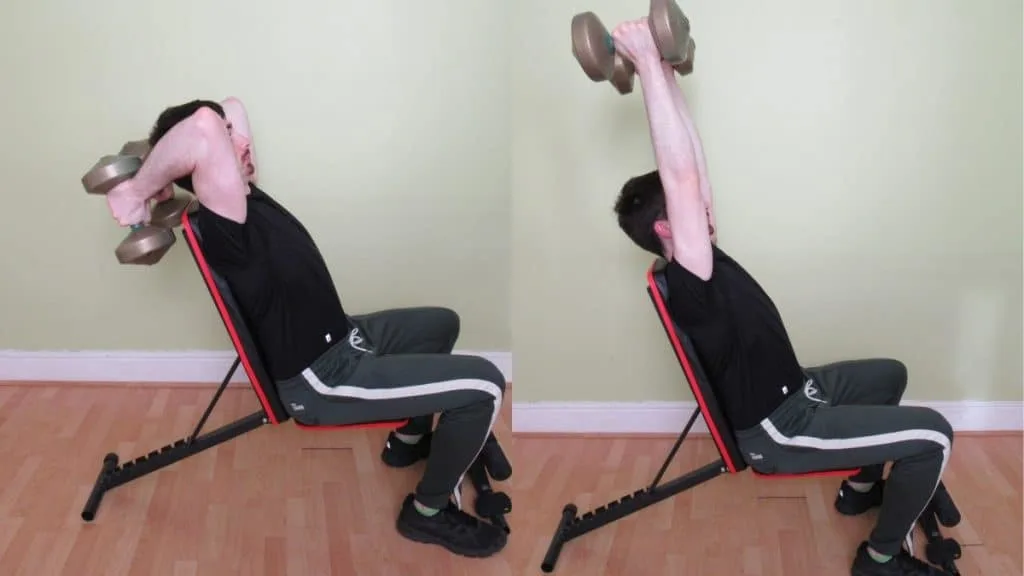 A man performing a seated dumbbell extension for his triceps