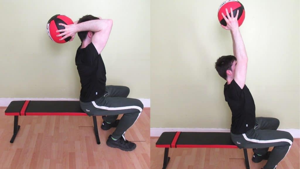 A man doing a seated med ball French press for his triceps