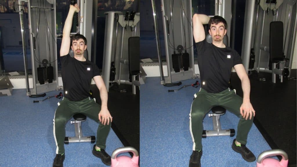 A man doing a seated one arm overhead cable triceps extension