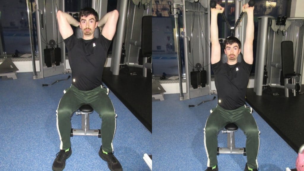 A man doing a seated overhead cable extension for his triceps