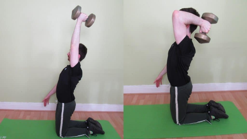 A man doing a single arm kneeling dumbbell tricep extension