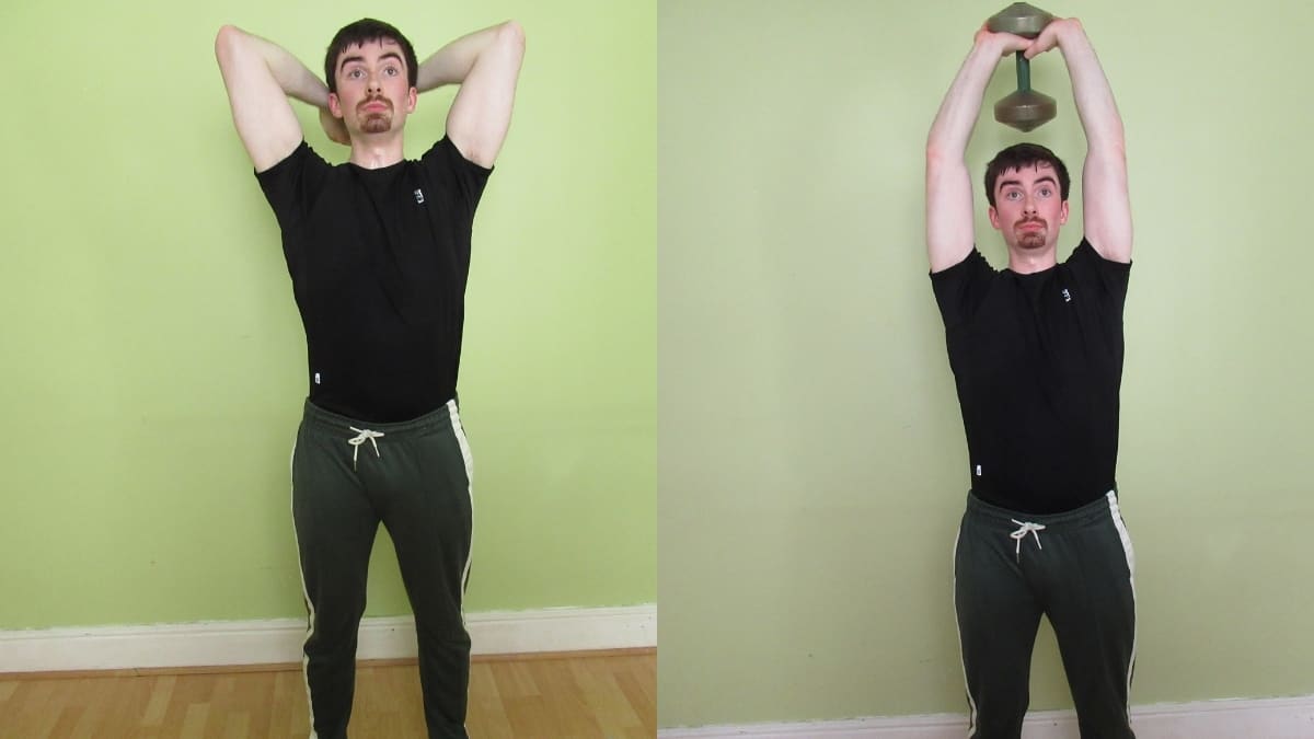 A man performing a standing dumbbell overhead tricep extension exercise