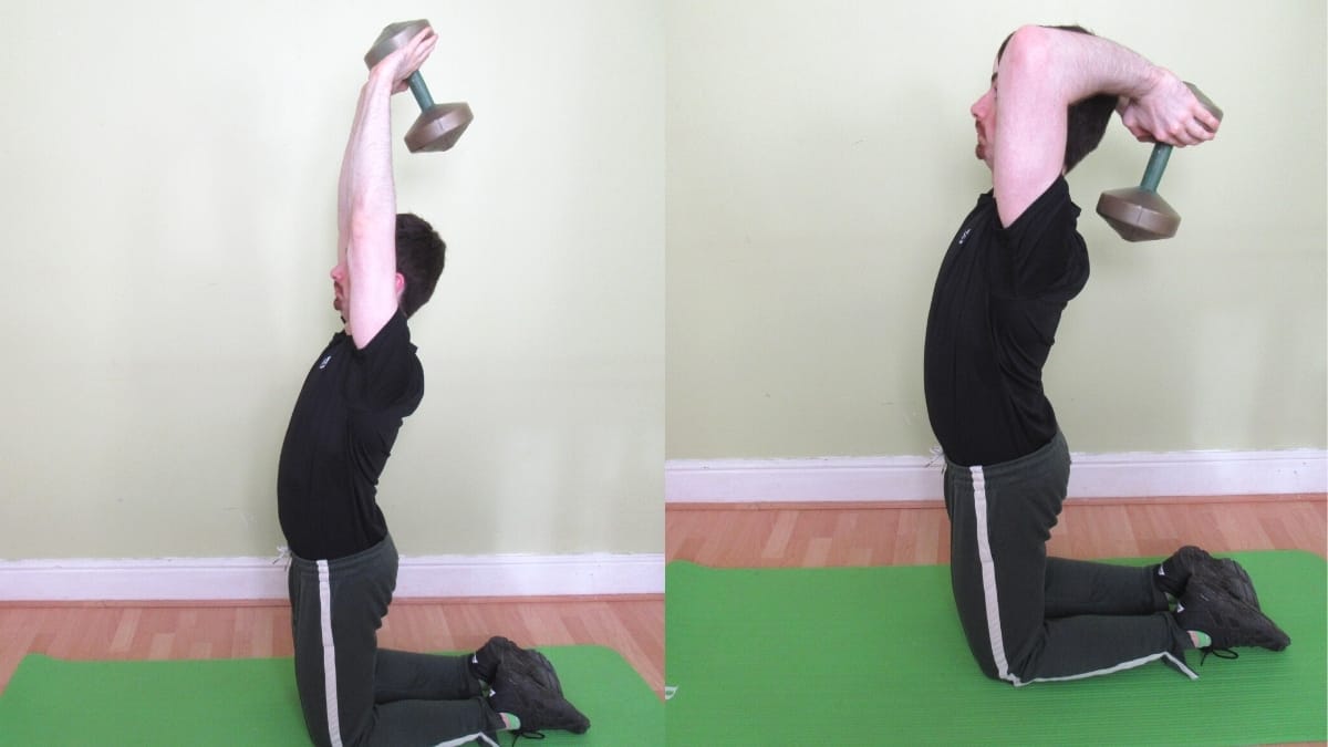 A man doing a tall kneeling French press with a dumbbell