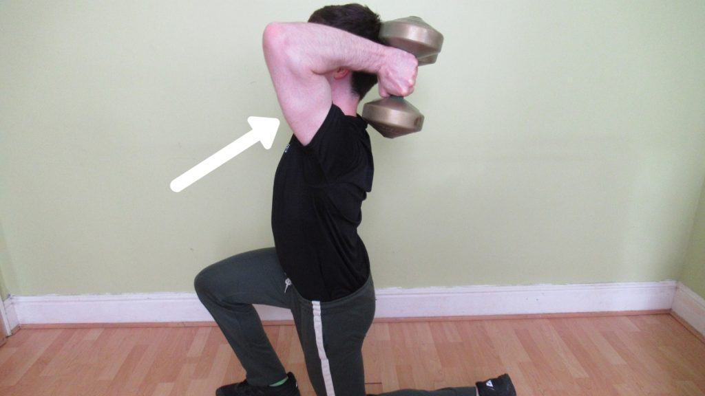 A man doing a tricep extension to lunge