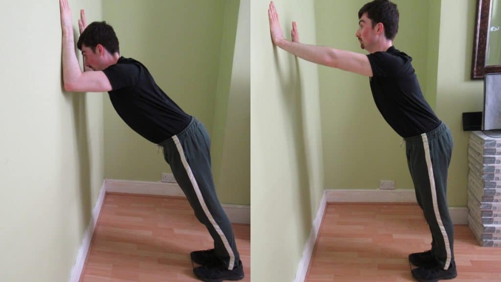 A man performing wall tricep pushes