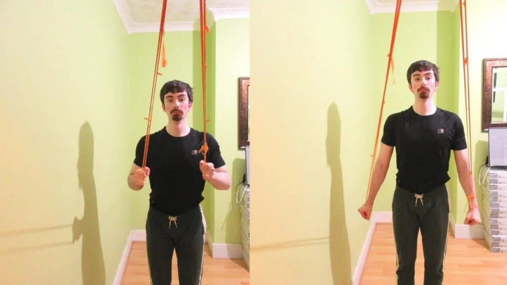 A man performing a resistance band pressdown for his triceps