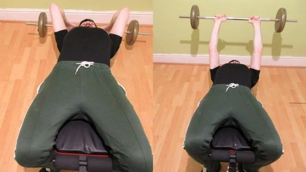 A man doing a decline barbell skull crusher