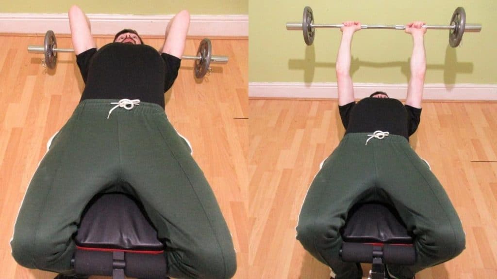 A man performing decline bench skull crushers