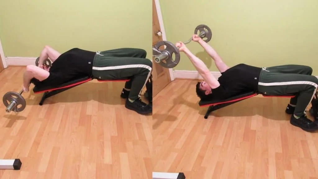 A man doing a decline EZ bar triceps extension