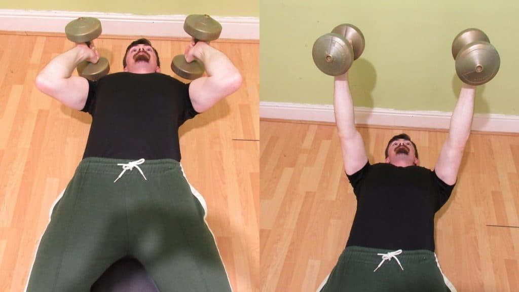 A man doing a decline triceps extension with dumbbells