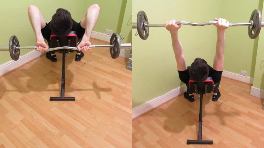 A man performing an EZ bar incline triceps extension