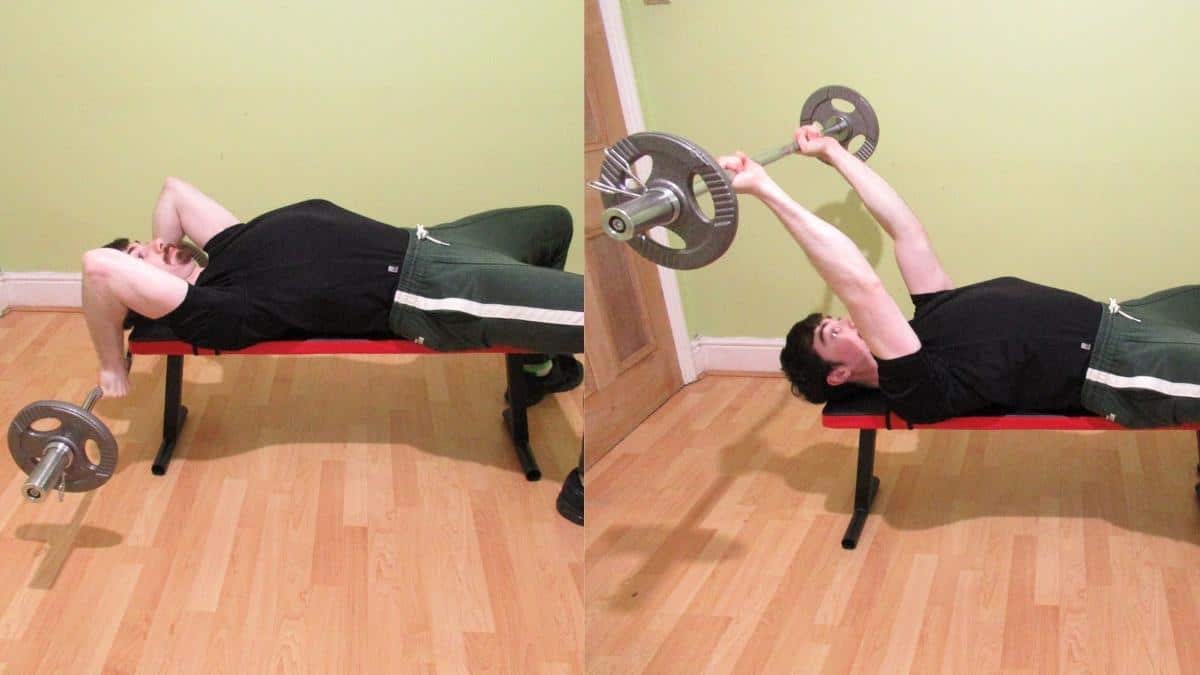 A man performing an EZ bar lying tricep extension on a flat bench