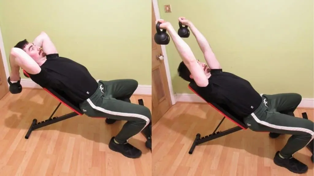 A man performing an incline kettlebell skull crusher