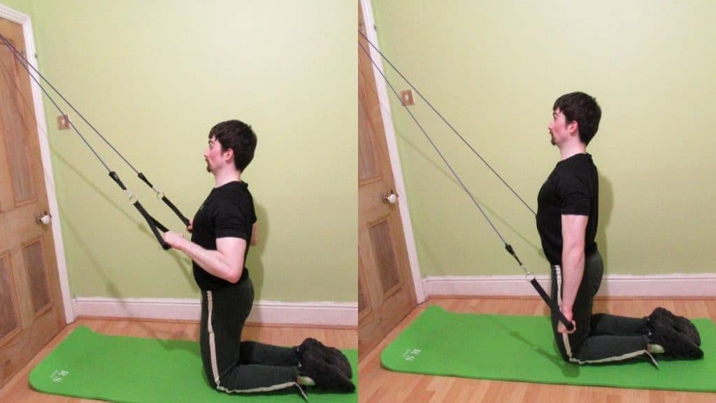 A man performing kneeling resistance band pushdowns for his triceps