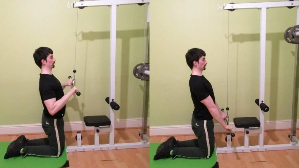 A man performing a kneeling tri pushdown