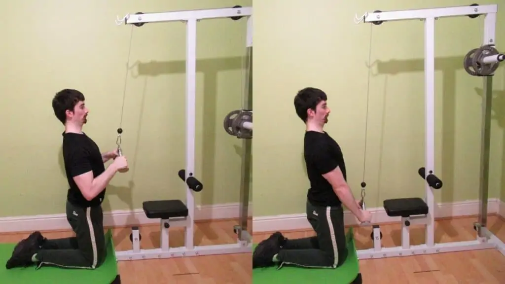 A man performing a kneeling v-bar pressdown